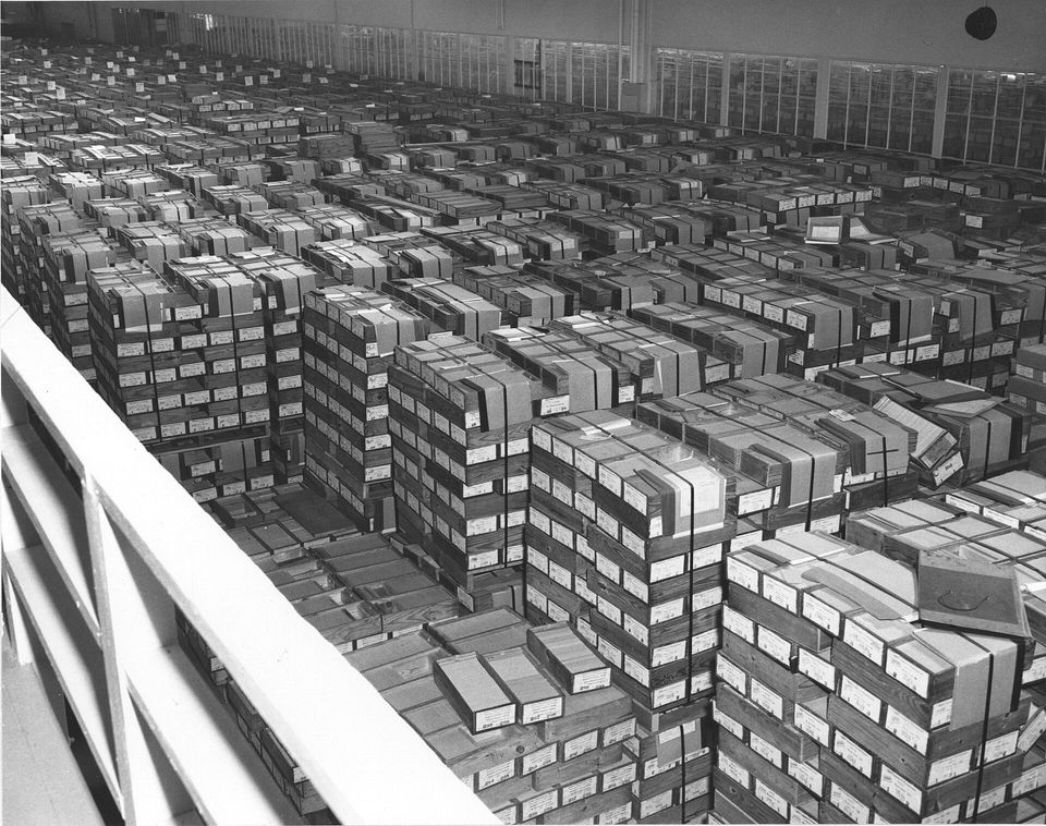 Long rows of stored IBM punch cards in a government records facility.