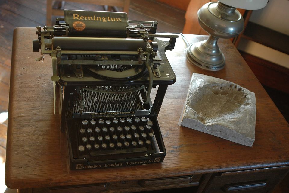 An antique Remington typewriter on a desk.
