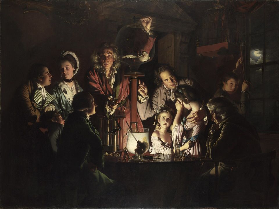 A natural philosopher demonstrates an air pump to a family gathered around a table by candlelight.