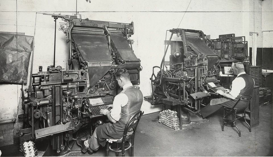 Operators setting type on Linotype machines.