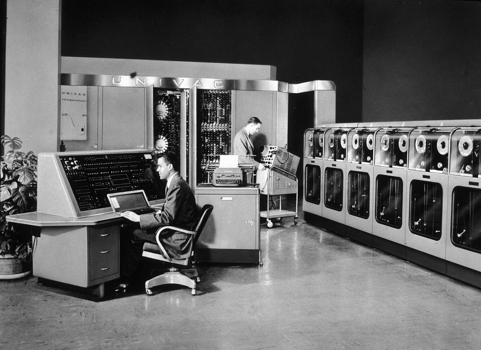 Staff gathered at the control console of the UNIVAC I computer.