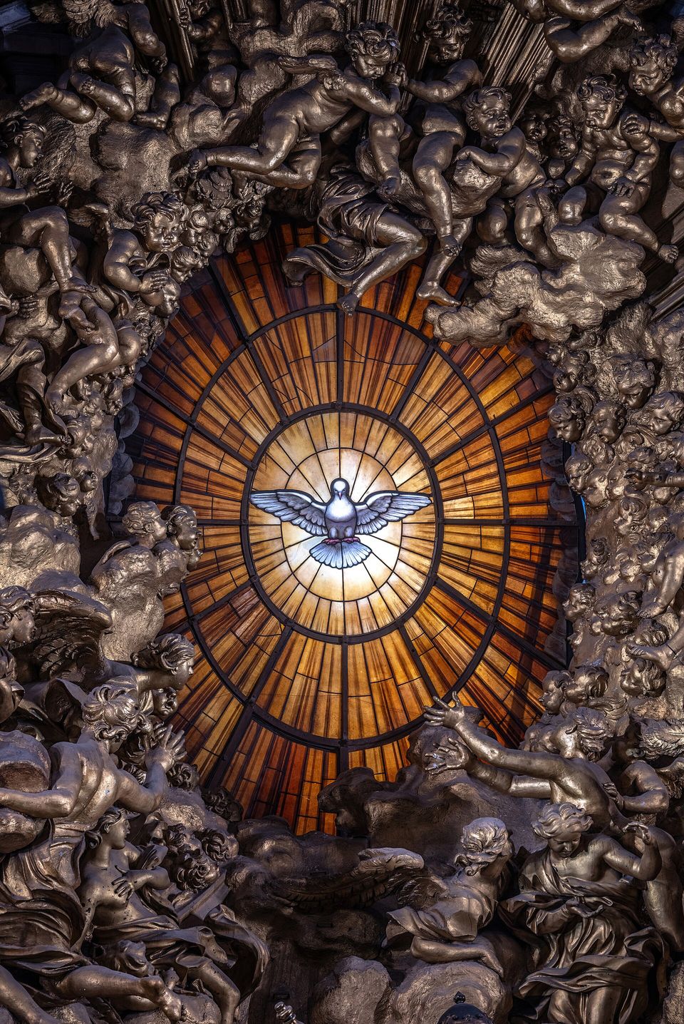 Bernini's golden stained-glass window in St. Peter's Basilica, with a white dove of the Holy Spirit at the center and rays of light spreading outward